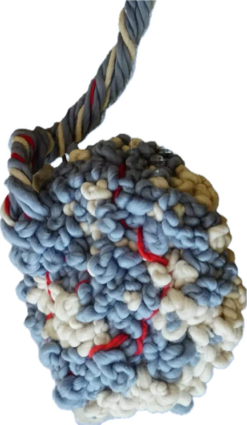 Hand-woven sculpture shaped like a placenta, in blue, cream and red yarn, with its umbilical cord rising upwards